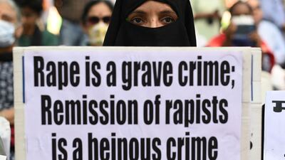 A demonstrator holds a placard during a protest against the release of men convicted of gangraping Bilkis Bano during the 2002 communal riots in Gujarat. AFP