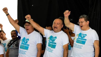 Leadre of Colombia’s Farc rebels, from left, Ricardo Tellez, Carlos Antonio Lozada and Pablo Catatumbo celebrate the approval of the peace deal with the government during the closing ceremony of the 10th National Guerrilla Conference in Llanos del Yari, Colombia, on September 23, 2016. Guillermo Munoz / AFP
