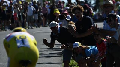 Spectators cheer UAE Emirates' Tadej Pogacar.