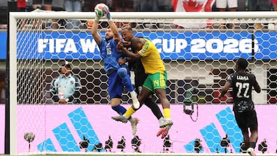 Canada goalkeeper Maxime Crepeau catches the ball above defender Derek Cornelius, wearing black, and South Africa's Mbekezeli Mbokazi at the Los Angeles Stadium. Canada won the last-32 clash 1-0, with a 92nd-minute strike. AFP