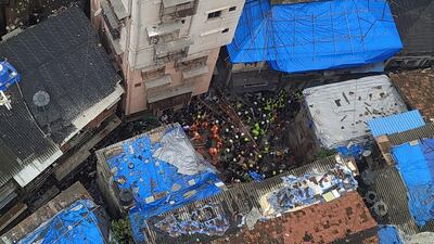Rescue workers search for survivors at the site of a collapsed building in Mumbai, India. Reuters
