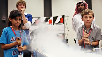 Reem Al Jabiri, left, of Al Shohob School and Jake Officer of Al Yasmena School at the F1 in Schools national finals. Fatima Al Marzooqi / The National