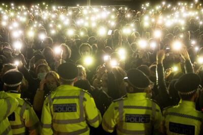 People gather for a vigil for Sarah Everard in Clapham Common in London. PA
