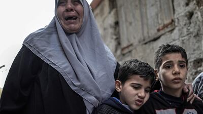 Sons and mother of Palestinian fisherman Abdallah Zidan mourn during his funeral in the streets of Al Shateaa refugee camp in Gaza. Mohammed Saber / EPA