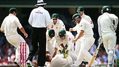 The Australia players rush to celebrate with Nathan Hauritz after he took the crucial wicket of Mohammad Yousuf yesterday.