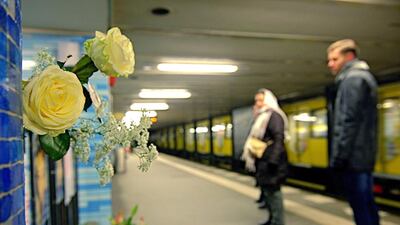 Flowers are placed on January 22, 2016, on the platform of the Ernst-Reuter-Platz subway station in Berlin, where a young woman was pushed in front of an arriving train by a man on Tuesday. The woman died and the offender was arrested on site. Paul Zinken / EPA