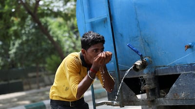 A labourer drinks water from a tanker at a construction site on a hot summer day in Noida. India is experiencing a heatwave in the northern and western parts of the country. Reuters