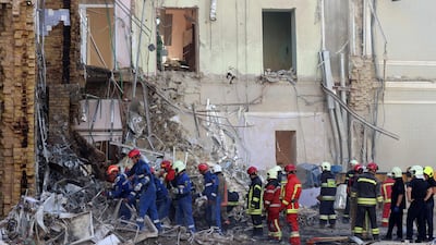 Rescue personnel clear the rubble of a destroyed building at the Ohmatdyt Children's Hospital, a day after a missile attack in Kyiv. AFP