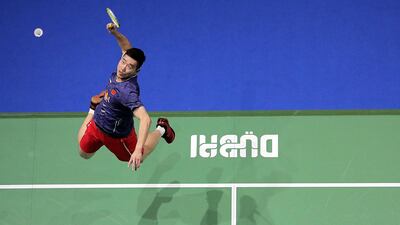 China's Liu Cheng returns the shot to Denmark's Mathias Boe and Carsten Mogensen during the third day of the Dubai Badminton World Superseries Finals in Dubai. Mahmoud Khaled / AFP Photo