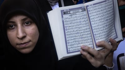 A woman holds a copy of the Quran during a protest outside the Swedish consulate in Istanbul on Sunday. Getty Images