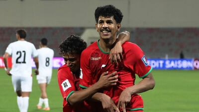 Oman's Essam Al Subhi celebrates scoring a 97th-minute penalty to earn a 1-1 draw against Palestine. Reuters