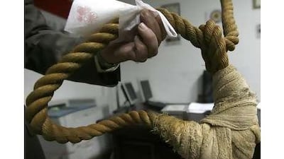 A museum worker shows reporters a noose that will be displayed in a new Iraqi museum in Baghdad.