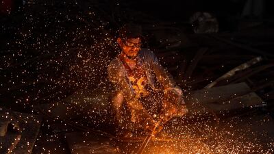 A worker cuts steel sheets at a rolling mill in Narayanganj, on the outskirts of Dhaka. AFP