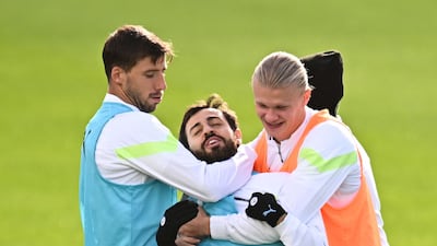 Ruben Dias, Bernardo Silva, centre, and Erling Haaland during training on Monday. AFP