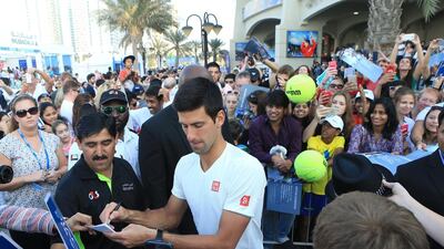 Novak Djokovic signs autographs at Zayed Sports City on Thursday for the Mubadala World Tennis Championship in Abu Dhabi. Ravindranath K / The National