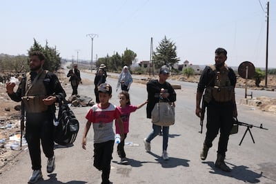 Government security forces escort Bedouin civilians leaving the city of Sweida following clashes in July. AFP