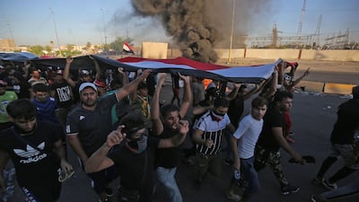 Iraqi protesters take part in a demonstration against state corruption, failing public services, and unemployment, in the Iraqi capital Baghdad's central Khellani Square. AFP