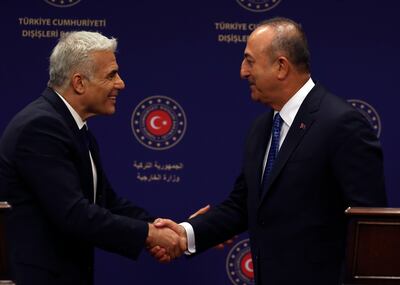 Turkish Foreign Minister Mevlut Cavusoglu, right, and Israeli Foreign Minister Yair Lapid after a press conference in Ankara on Thursday. AP