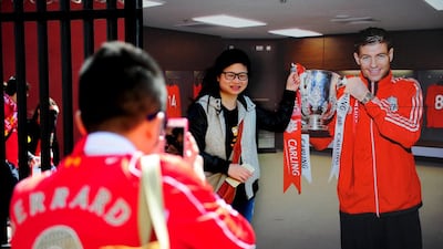 Liverpool fans take photographs with a Steven Gerrard picture. Stu Forster / Getty Images