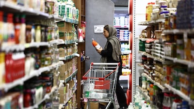 A woman in Tehran shops for groceries, some of which are becoming too expensive for the average Iranian to buy. Reuters