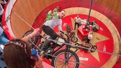Donald Ganslmeier, operator of the Motodrom, rides a motorbike inside the Motodrom during a press tour at Theresienwiese on the premises of the 182nd annual Oktoberfest in Munich. Matthias Balk / EPA