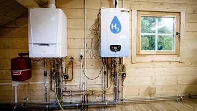 An old central heating boiler and a hydrogen boiler. Climate Assembly UK examined pathways to achieve the British government’s target to reduce greenhouse gas emissions by 2050. AFP