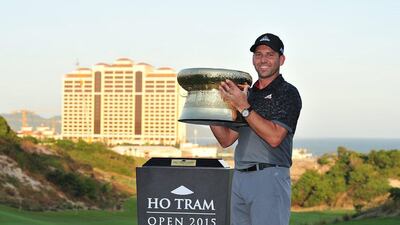 Sergio Garcia of Spain poses with the championship trophy after the final round of the of the Ho Tram Open in Ho Tram, Vietnam on December 6, 2015. AFP PHOTO / ASIAN TOUR / Khalid Redza