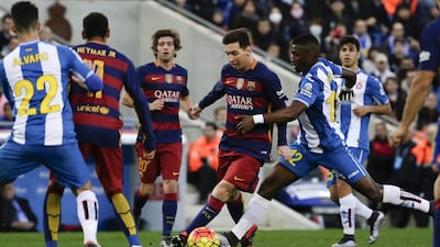 Liobnel Messi, centre, in action against Espanyol. Emilio Morenatti / AP Photo