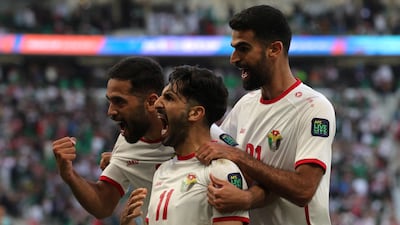 Jordan's Yazan Al Naimat celebrates with teammates after scoring his team's second goal in their Asian Cup match against South Korea at the Al Thumama Stadium. AFP