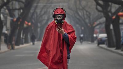A man wears a protective mask, goggles and coat as he stands in a nearly empty street during the Chinese New Year holiday in Beijing. China has restricted the movements of over 50 million people to contain the virus. Getty Images