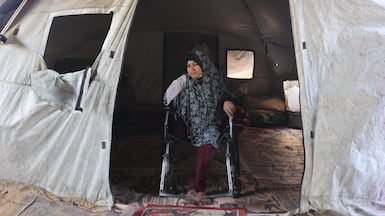 Displaced Palestinian Maryam Abu Warda, 46, who lost her right hand and right leg when the Israeli army attacked her home, shelters in her tent at Halawa camp in Jabalia, northern Gaza Strip. AFP