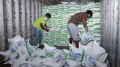 Workers sort out bags of rice seized from a private warehouse in the eastern city of Polonnaruwa, after Sri Lanka declared a state of emergency as most private banks ran out of foreign currency to finance imports of essentials, triggering food shortages. AFP