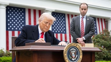 US President Donald Trump signs an executive order after delivering remarks on reciprocal tariffs in the Rose Garden at the White House in Washington. AFP