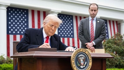US President Donald Trump signs an executive order after delivering remarks on reciprocal tariffs in the Rose Garden at the White House in Washington. AFP