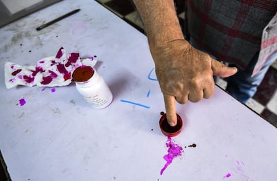 An Egyptian man dips a finger in ink after voting in the referendum. AFP