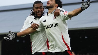 Raul Jimenez celebrates with Alex Iwobi after putting Fulham into an early lead. Reuters