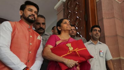 Indian Finance Minister Nirmala Sitharaman (C) and junior Finance Minister Anurag Thakur (L) before presenting the annual federal budget in New Delhi, India. AP