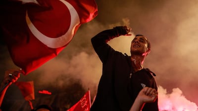 A supporter of Turkey's President Recep Tayyip Erdogan celebrates outside the AKP party headquarters in Istanbul. Emrah Gurel / AP