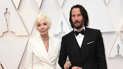 Patricia Taylor and Keanu Reeves, wearing Dolce & Gabbana, arrive at the Oscars on Sunday, February 9, 2020, at the Dolby Theatre in Los Angeles. AP