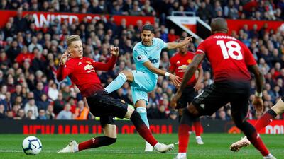 Newcastle United's Ayoze Perez has a shot at goal as Manchester United's Scott McTominay attempts to block. Reuters