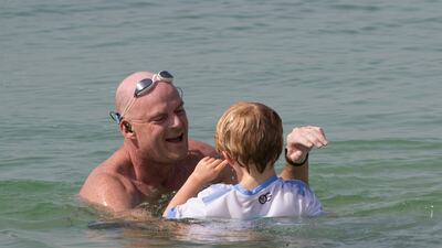 Dubai, United Arab Emirates - Will Follet son welcoming him on the shore at his solo swim around Palm Jumeirah for charity at West Palm Beach, Dubai. Ruel Pableo for The National