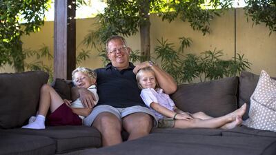 The British expat David Baker, a stay-at-home father, with his children William, 7, left, and Matilda, 5. Christopher Pike / The National