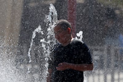 A boy cools off at a sprinkler in Mesa, Arizona. Getty Images / AFP