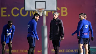 Barcelona manager Quique Setien talks with Lionel Messi during a training session at Joan Gamper Sports City. AFP