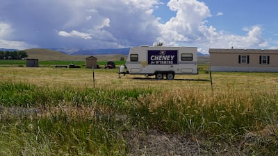 A Cheney sign hangs from a motor home on the side of a state highway.