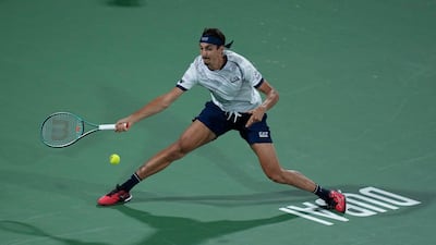 Lorenzo Sonego of Italy stretches to make a return against Daniil Medvedev. AP