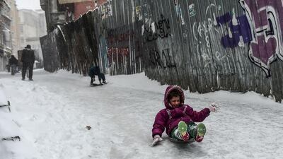 A child goes sledging during snowfalls in Istanbul. The weather was part of a cold spell across Europe that has killd at least 20 people in two days. Asin Akgul