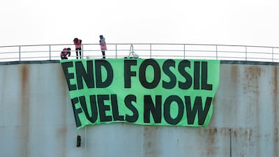 Extinction Rebellion activists on a storage tank at Esso West London Terminal, in Staines. Reuters