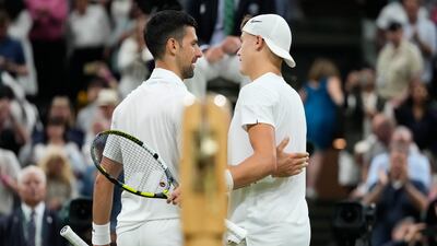 Novak Djokovic, left, is congratulated by Holger Rune. AP
