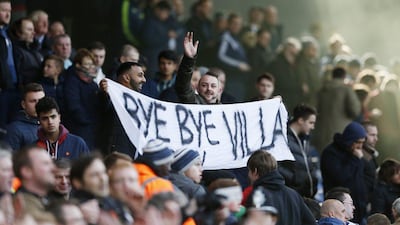 Fans hold up a sign aimed at Aston Villa after the game. Action Images via Reuters / Andrew Boyers